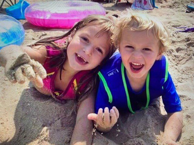 Two kids playing on the beach