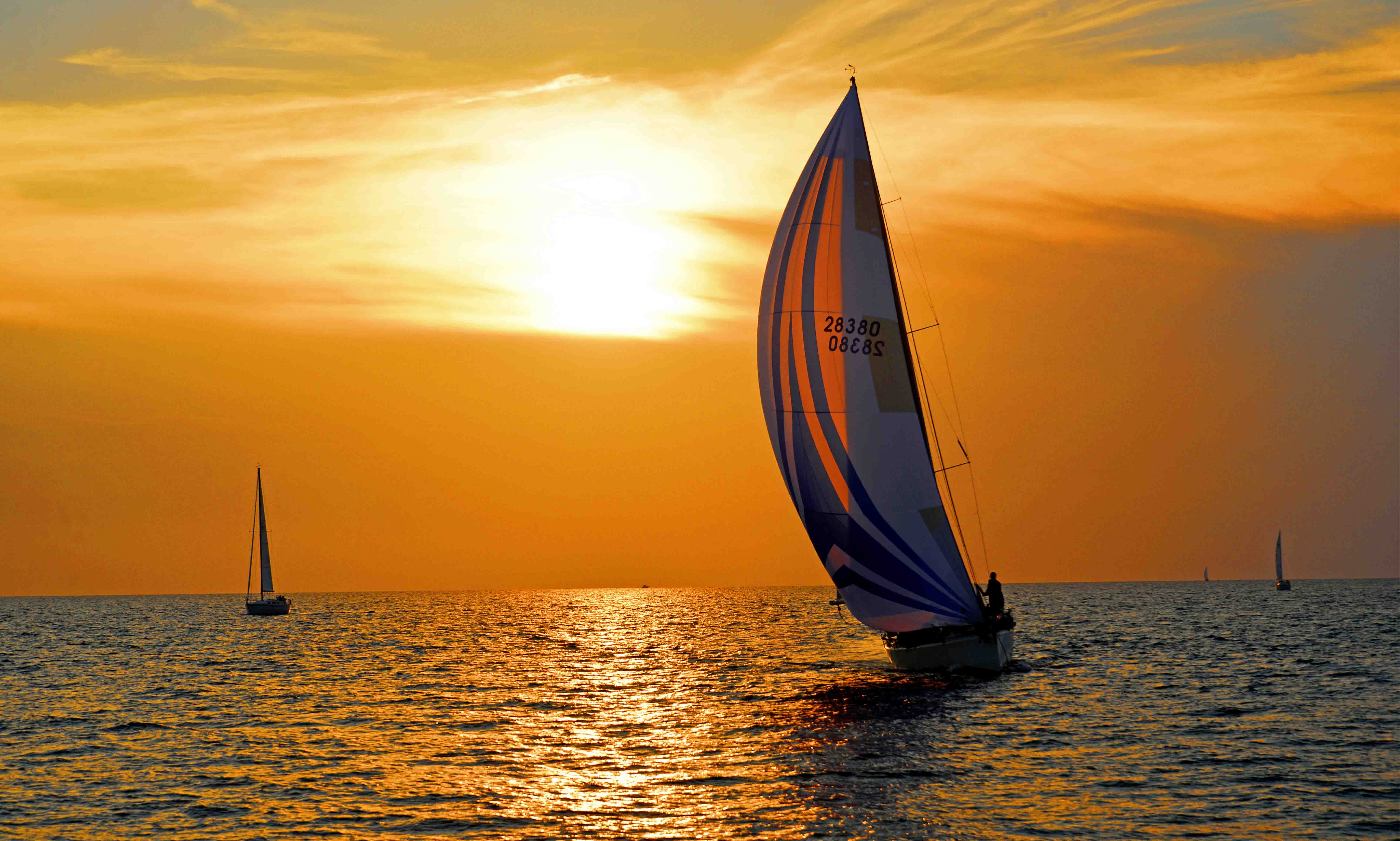 Boat sailing in the water with the sunset