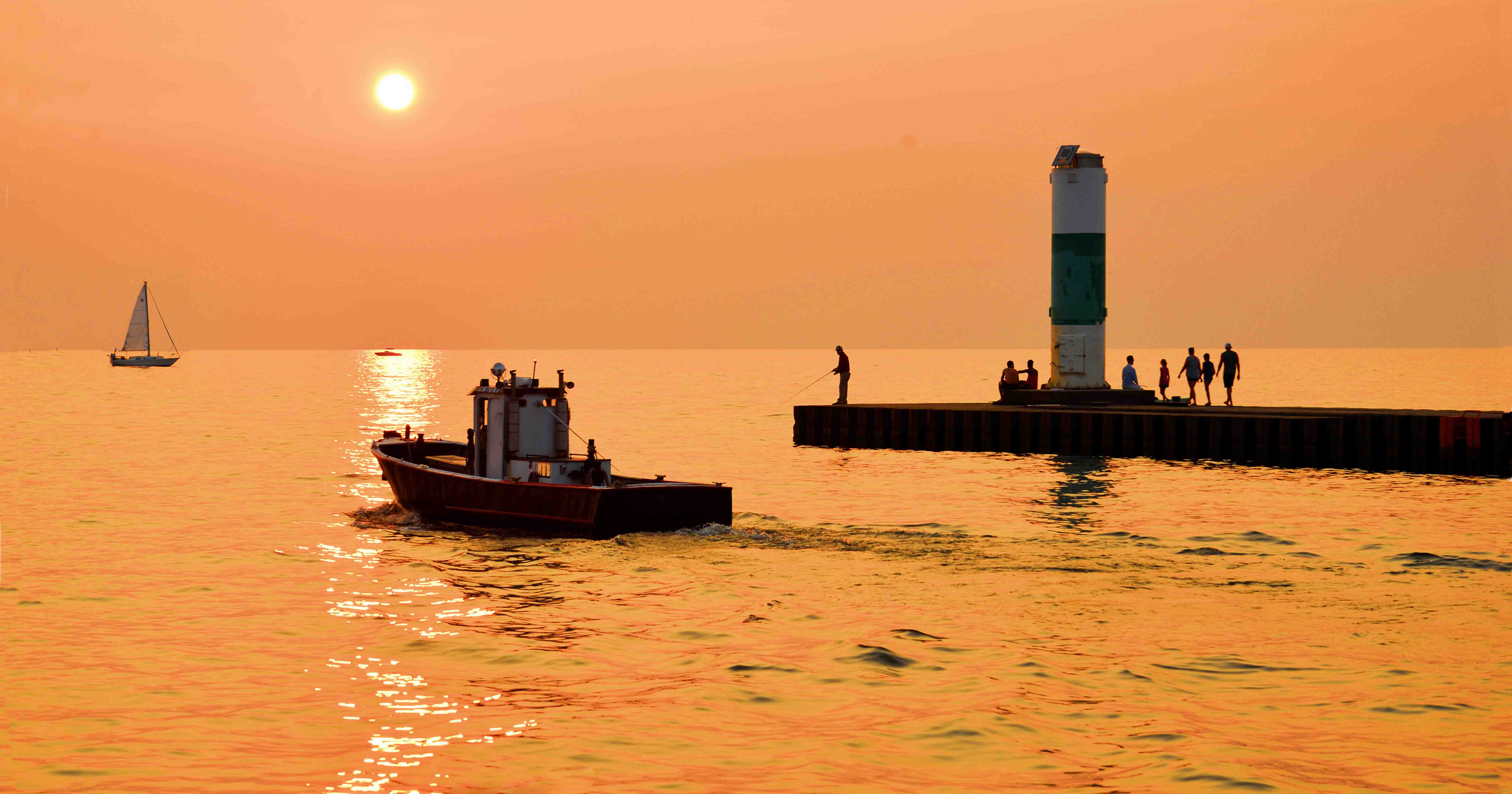 Sunset photo with a boat and lighthouse