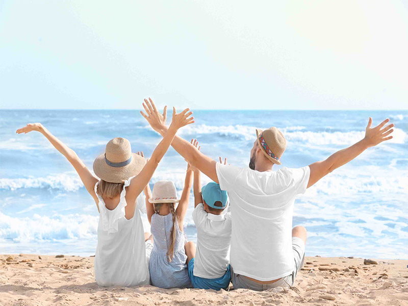Family happy on sitting in the sand