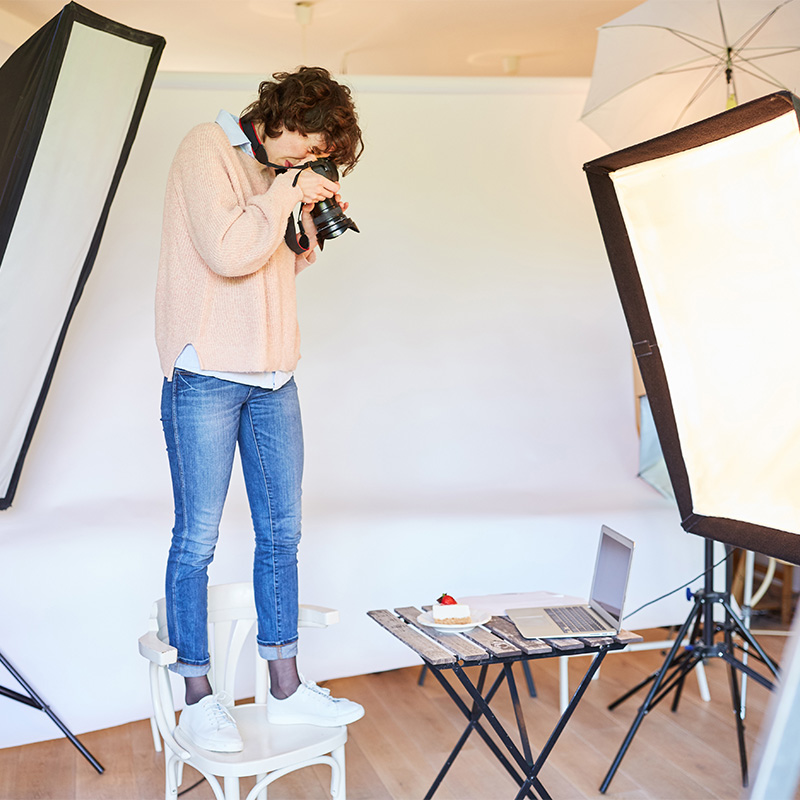 Photographer taking pictures of posed materials